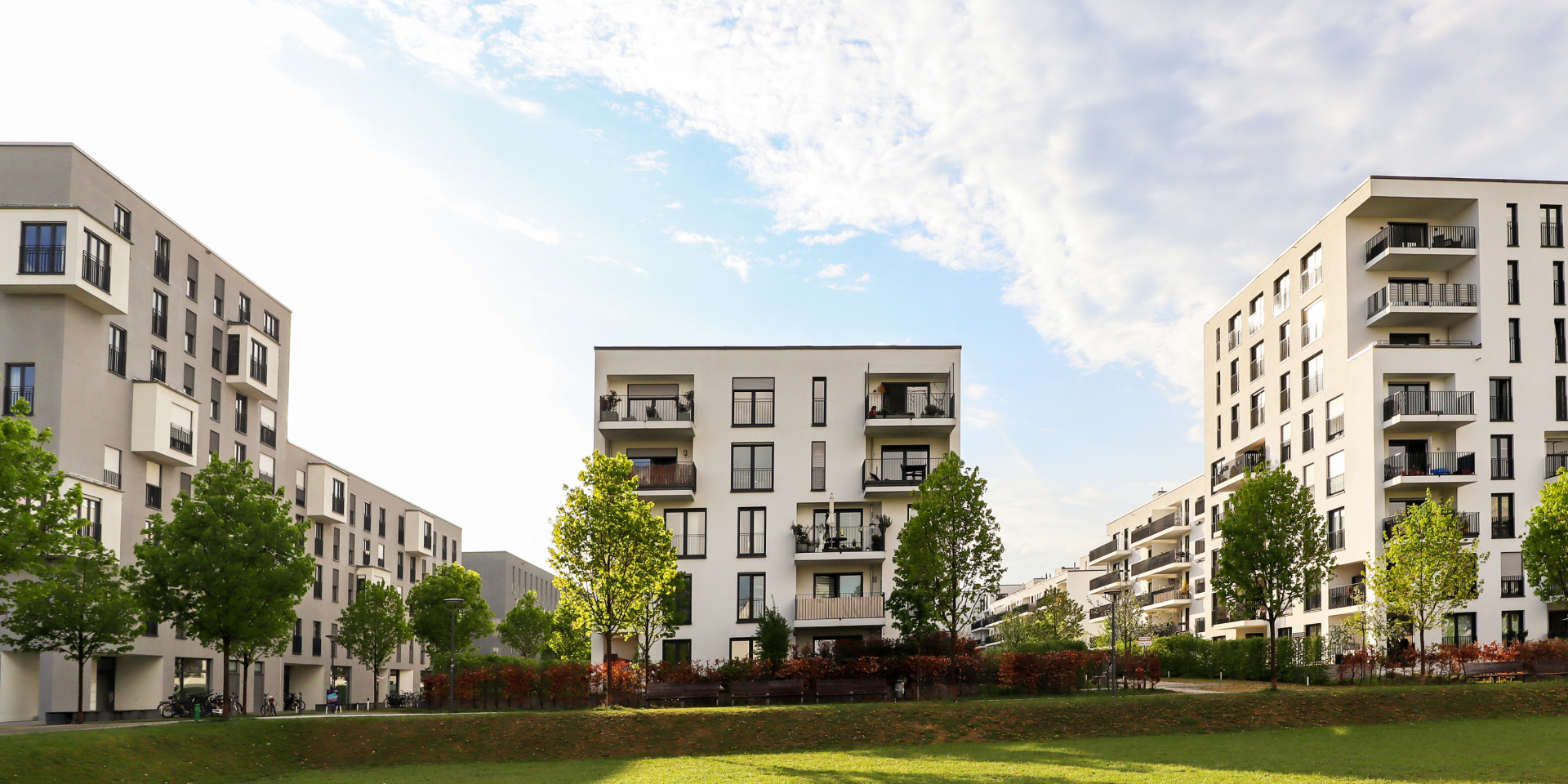 Modern apartment buildings with green space.
